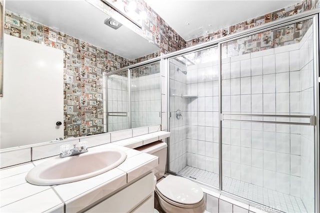 16512 Blackbeard Ln Unit 102, Huntington Beach, CA 92649 - bathroom featuring toilet, a shower stall, vanity, and wallpapered walls