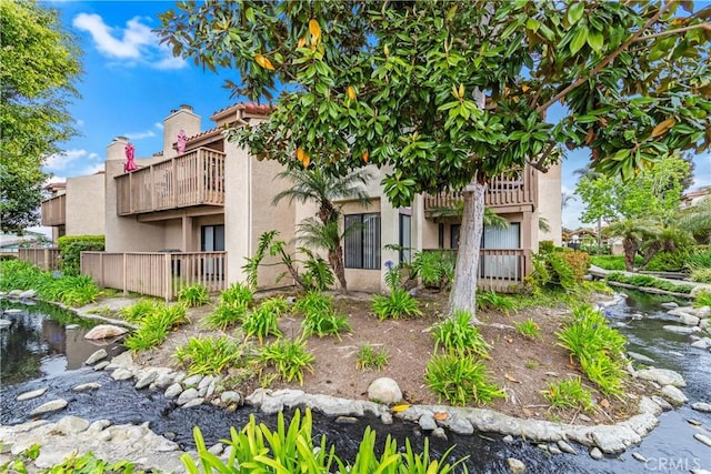 16512 Blackbeard Ln Unit 102, Huntington Beach, CA 92649 - back of house featuring a balcony, stucco siding, and fence