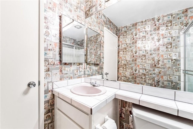 16512 Blackbeard Ln Unit 102, Huntington Beach, CA 92649 - full bath with vanity, wallpapered walls, and an enclosed shower