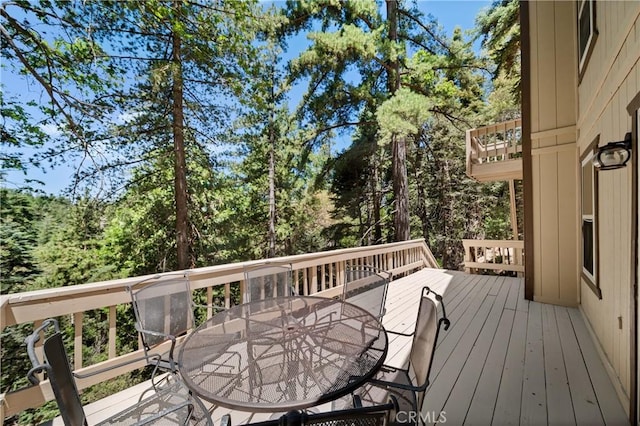 wooden terrace with outdoor dining space