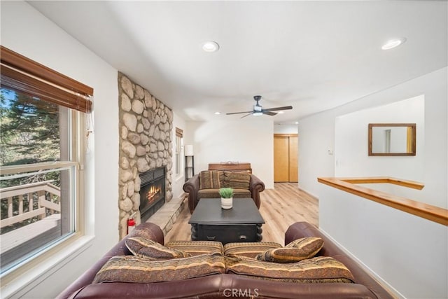 living area with light wood finished floors, a ceiling fan, a fireplace, and recessed lighting