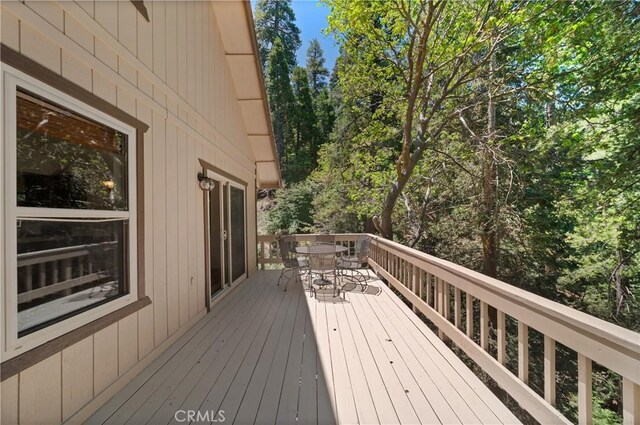 wooden deck featuring outdoor dining space
