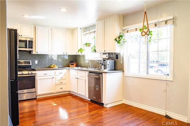 18711 Cerise Ave, Torrance, CA 90504 - kitchen with appliances with stainless steel finishes, tasteful backsplash, white cabinets, wood finished floors, and recessed lighting