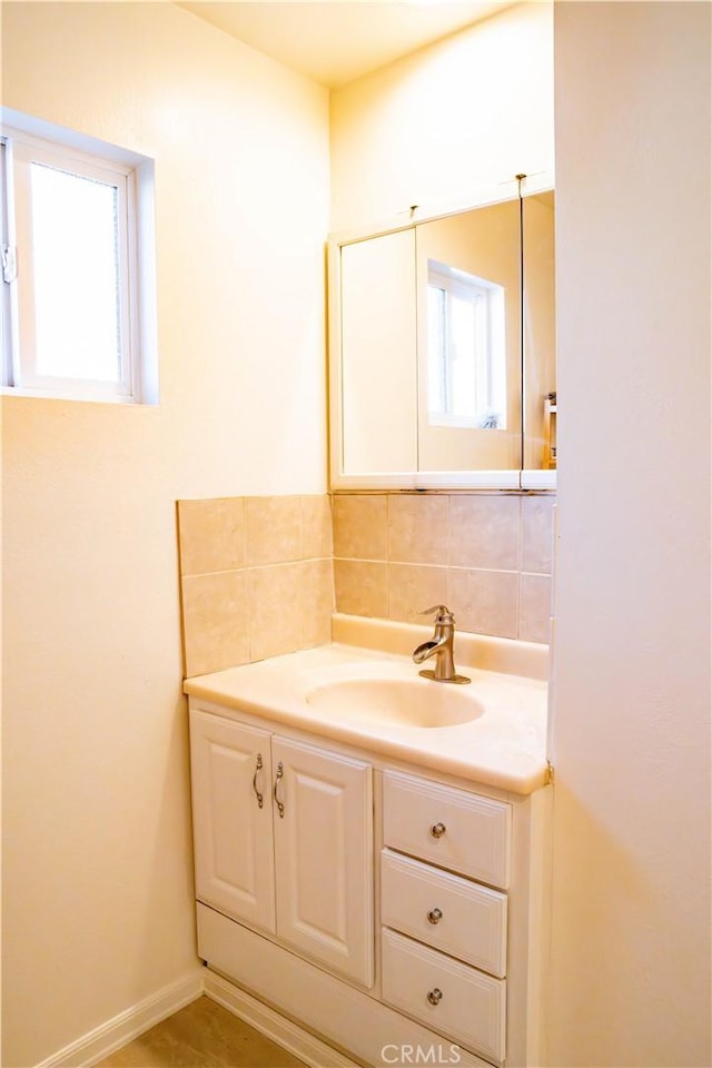 18711 Cerise Ave, Torrance, CA 90504 - bathroom with healthy amount of natural light, vanity, decorative backsplash, and baseboards