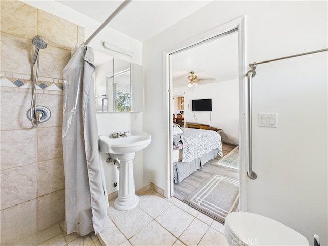 40170 Hillsborough Loop, Oakhurst, CA 93644 - full bath with a tile shower, toilet, tile patterned floors, connected bathroom, and ceiling fan