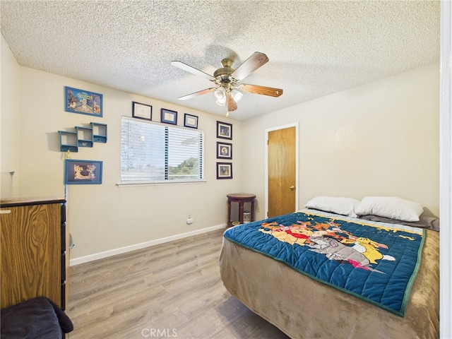 40170 Hillsborough Loop, Oakhurst, CA 93644 - bedroom with light wood-style floors, a textured ceiling, baseboards, and ceiling fan