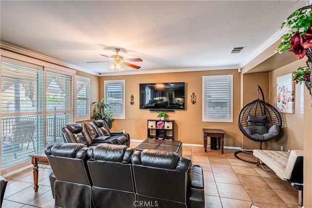 living room with light tile patterned floors, crown molding, a ceiling fan, and baseboards