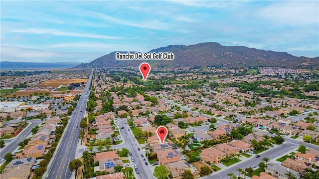 view of property location with mountains and nearby suburban area