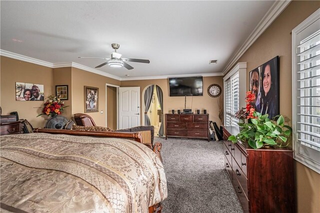 carpeted bedroom featuring crown molding and ceiling fan