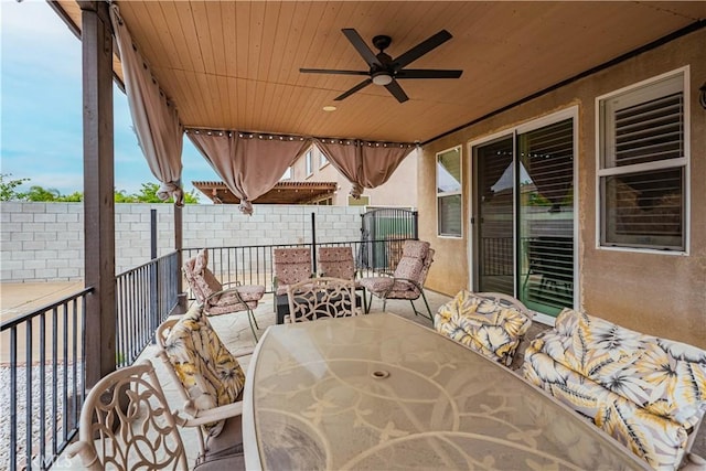 view of patio / terrace featuring ceiling fan, outdoor dining area, and fence