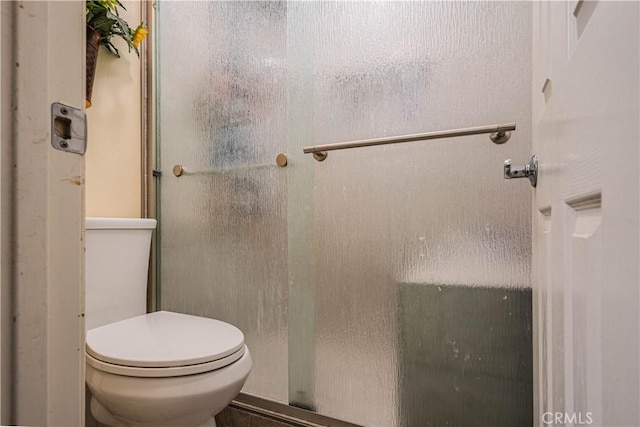 full bath with toilet and a stall shower