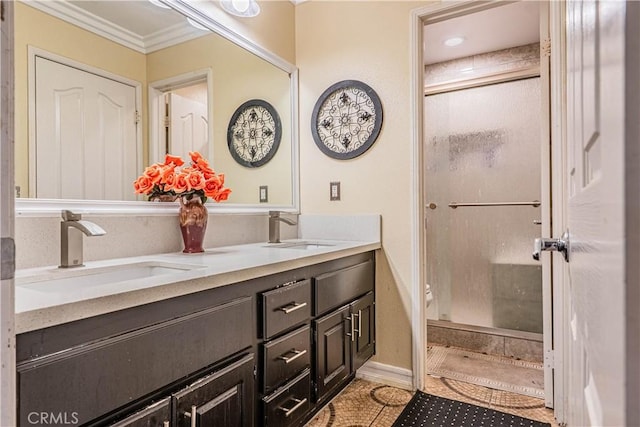 full bath with a stall shower, tile patterned floors, double vanity, and crown molding