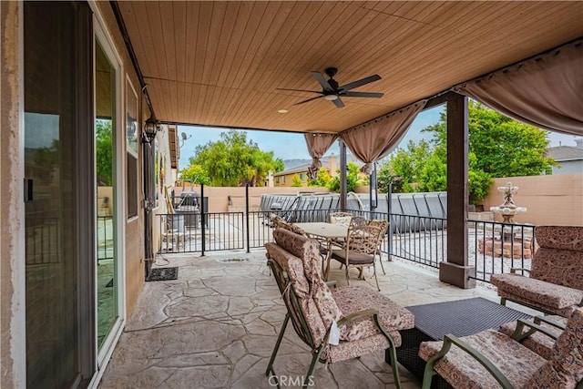 view of patio featuring a fenced backyard, ceiling fan, and outdoor dining area