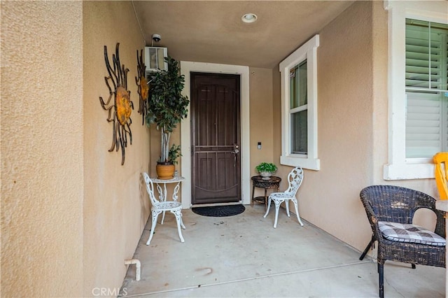 view of exterior entry featuring stucco siding