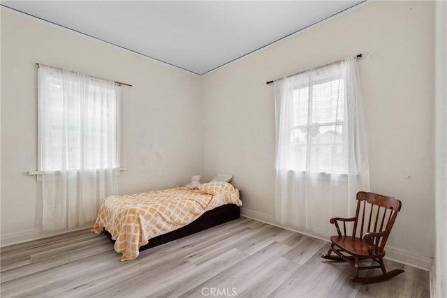 bedroom with wood finished floors and baseboards