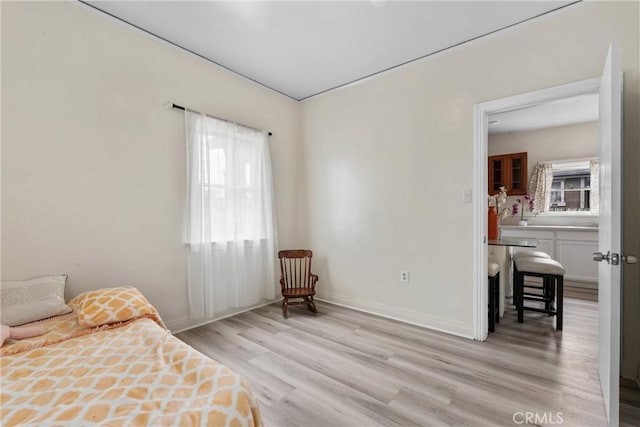 bedroom featuring light wood-type flooring and baseboards