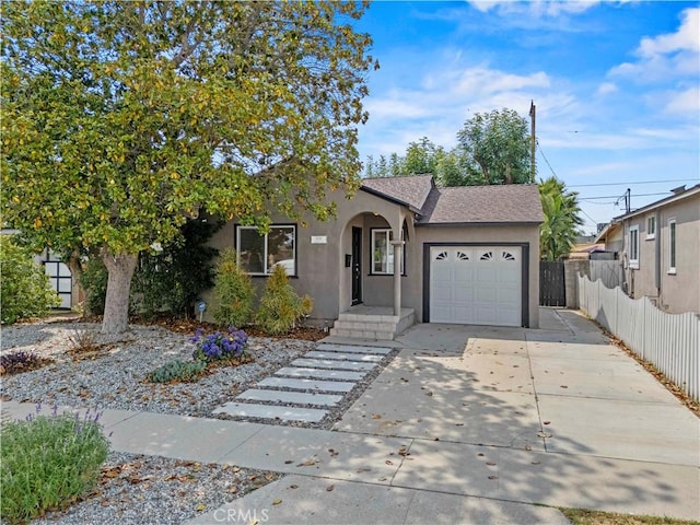 5826 Jamieson Ave, Encino, CA 91316 - view of front of house featuring stucco siding, an attached garage, driveway, and roof with shingles