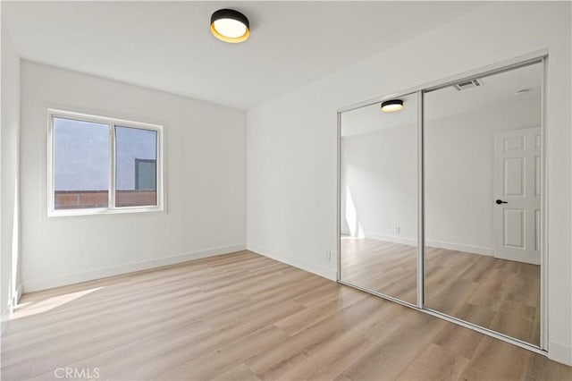 5826 Jamieson Ave, Encino, CA 91316 - unfurnished bedroom featuring light wood-type flooring, a closet, and baseboards