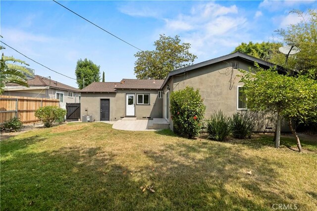 5826 Jamieson Ave, Encino, CA 91316 - back of house with stucco siding, a gate, and central AC unit