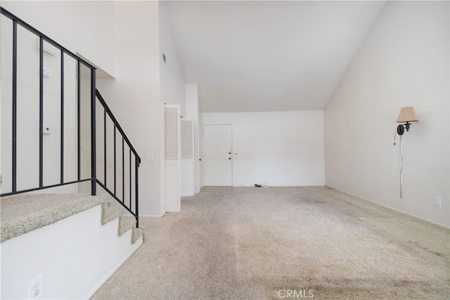 carpeted foyer featuring stairway