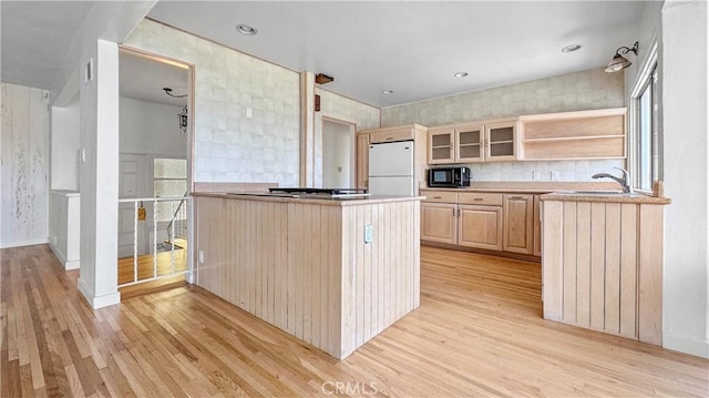 2001 Kenilworth Ave, Los Angeles, CA 90039 - kitchen featuring freestanding refrigerator, light brown cabinets, light wood-style floors, black microwave, and glass insert cabinets