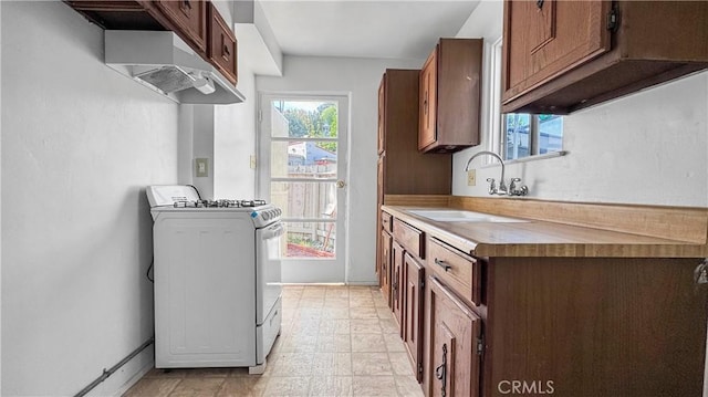 2001 Kenilworth Ave, Los Angeles, CA 90039 - kitchen featuring gas range, a sink, plenty of natural light, and light countertops