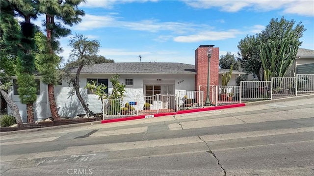 2001 Kenilworth Ave, Los Angeles, CA 90039 - view of front of property with stucco siding, fence, and a chimney