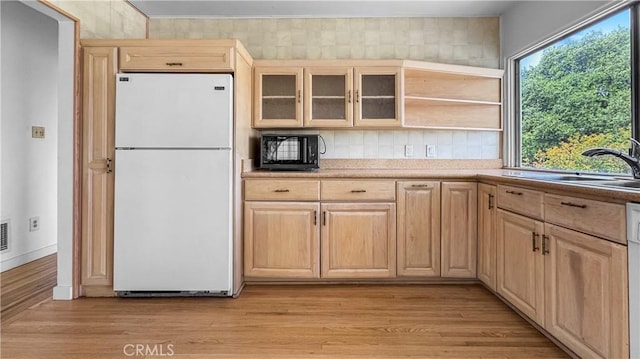 2001 Kenilworth Ave, Los Angeles, CA 90039 - kitchen with freestanding refrigerator, light brown cabinetry, tasteful backsplash, glass insert cabinets, and black microwave
