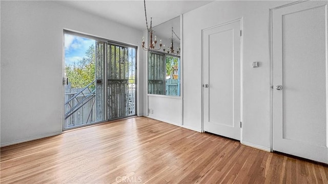 2001 Kenilworth Ave, Los Angeles, CA 90039 - unfurnished dining area with a chandelier and wood finished floors