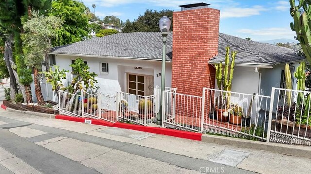 2001 Kenilworth Ave, Los Angeles, CA 90039 - exterior space featuring roof with shingles, stucco siding, a chimney, and fence