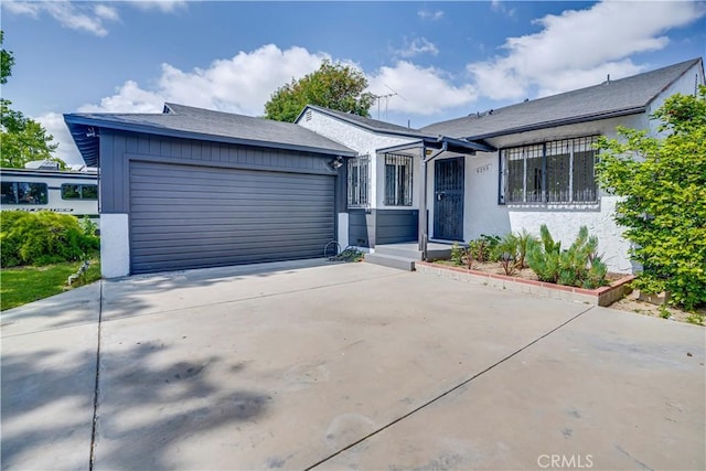 6255 Satsuma Ave, North Hollywood, CA 91606 - view of front of home with an attached garage, concrete driveway, and stucco siding