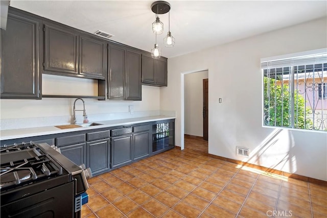 6255 Satsuma Ave, North Hollywood, CA 91606 - kitchen featuring a sink, gas range, light countertops, and hanging light fixtures
