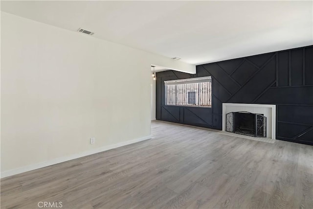6255 Satsuma Ave, North Hollywood, CA 91606 - unfurnished living room with wood finished floors, baseboards, and a fireplace
