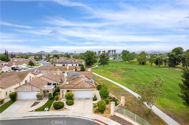 aerial view of residential area with mountains and a golf course