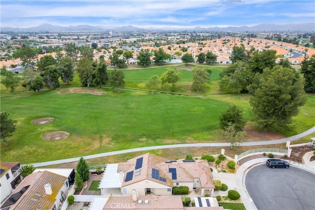 aerial view of residential area with mountains and a local golf course
