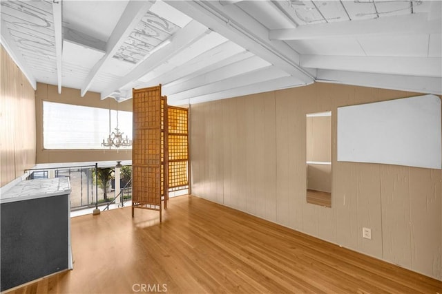 4662 Howard Ave, Los Alamitos, CA 90720 - additional living space with wood finished floors, a chandelier, and wooden walls