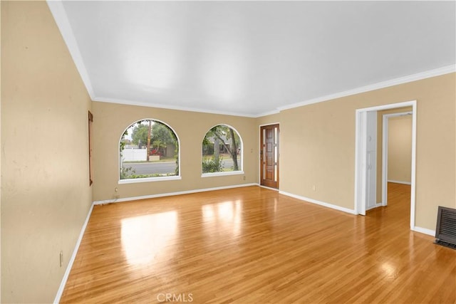 4662 Howard Ave, Los Alamitos, CA 90720 - unfurnished living room with baseboards, crown molding, and light wood-style flooring