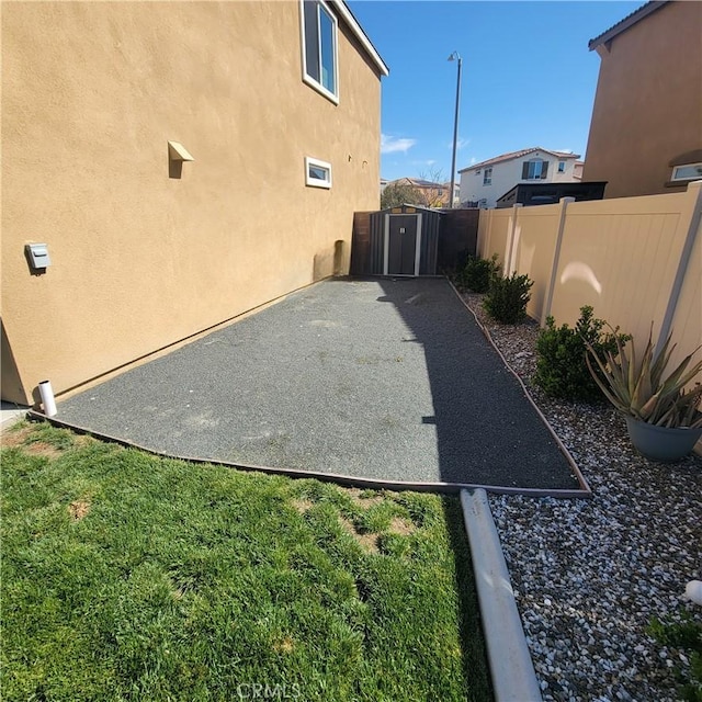 view of patio with fence and a gate