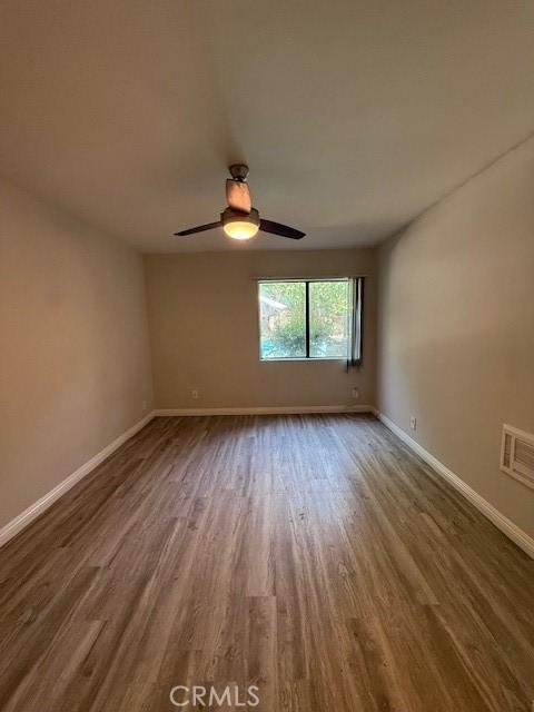 20234 Cantara St Unit 143, Winnetka, CA 91306 - unfurnished room featuring dark wood-style floors and a ceiling fan