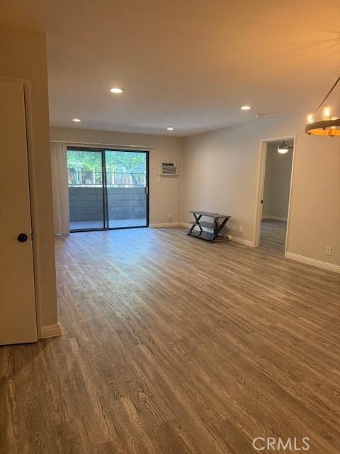 20234 Cantara St Unit 143, Winnetka, CA 91306 - unfurnished living room featuring wood finished floors and recessed lighting