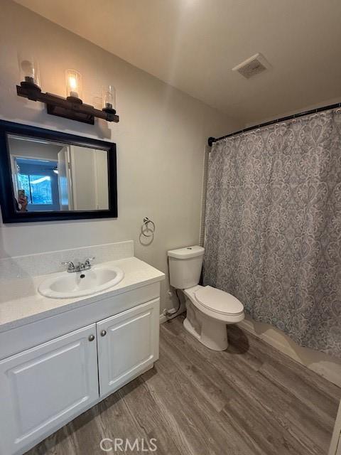 20234 Cantara St Unit 143, Winnetka, CA 91306 - bathroom featuring wood finished floors, vanity, and a shower with curtain
