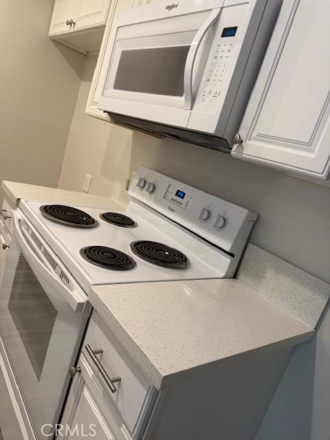 20234 Cantara St Unit 143, Winnetka, CA 91306 - kitchen featuring white appliances, light countertops, and white cabinets