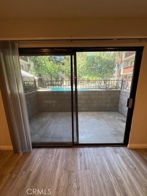 20234 Cantara St Unit 143, Winnetka, CA 91306 - doorway to outside featuring wood finished floors