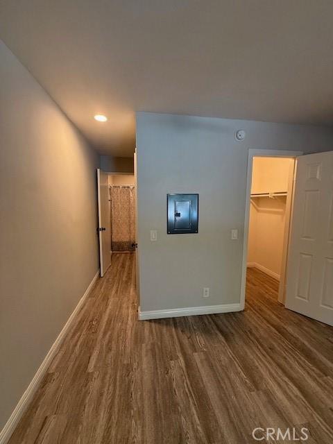 20234 Cantara St Unit 143, Winnetka, CA 91306 - unfurnished bedroom with wood finished floors, a walk in closet, and electric panel