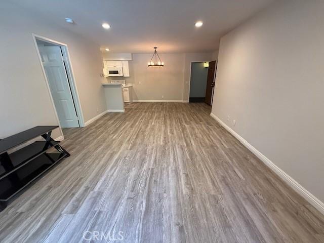 20234 Cantara St Unit 143, Winnetka, CA 91306 - unfurnished living room featuring a chandelier, wood finished floors, and recessed lighting