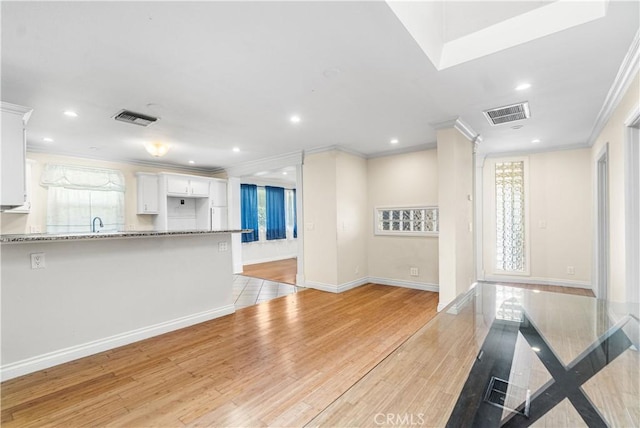 1731 E Wardlow Rd, Long Beach, CA 90807 - unfurnished living room featuring crown molding, recessed lighting, light wood-type flooring, and baseboards