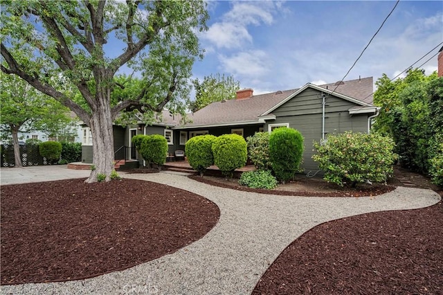 single story home with curved driveway and a patio
