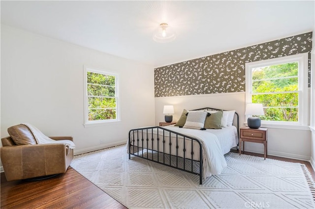 bedroom with baseboards and wood finished floors