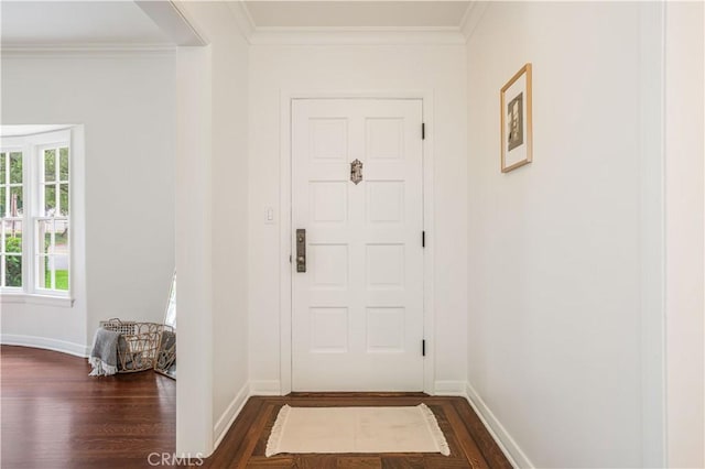 entryway with dark wood-type flooring, crown molding, and baseboards