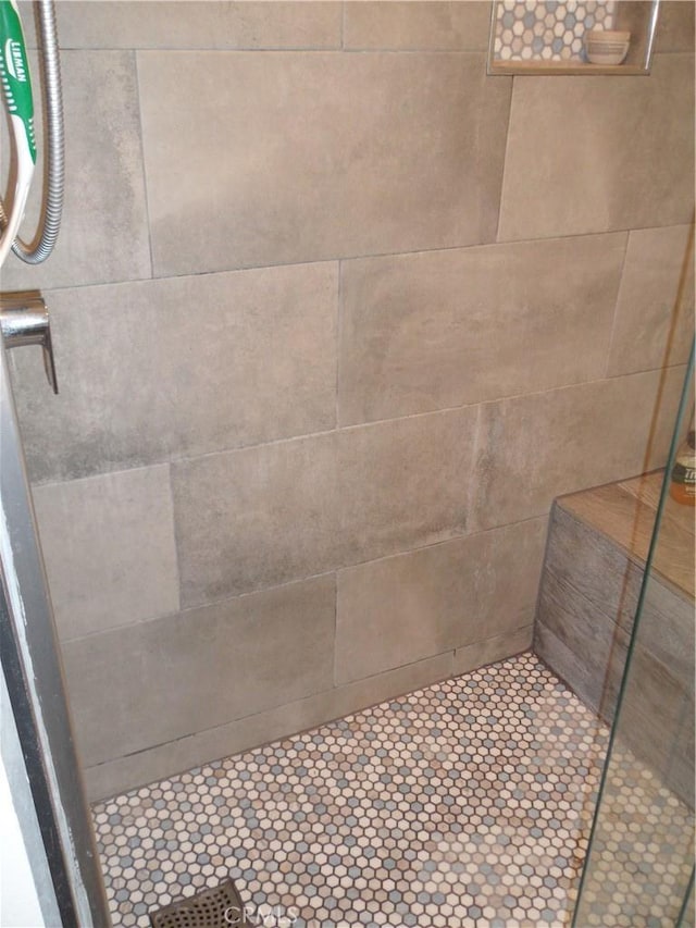 bathroom with tiled shower
